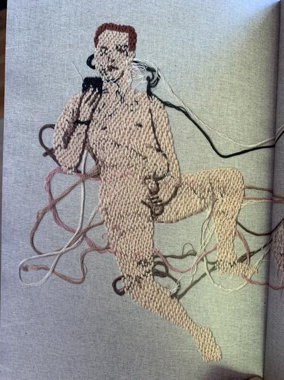 A naked man on his phone holds his penis. Rendered in embroidery on muslin. Some of the threads are not tied off, extending away from his body untidily, but adding to the texture and imperfection of the image.