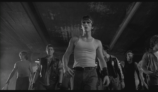 Black and white still looking up at Rusty James and crew strutting their stuff towards the camera