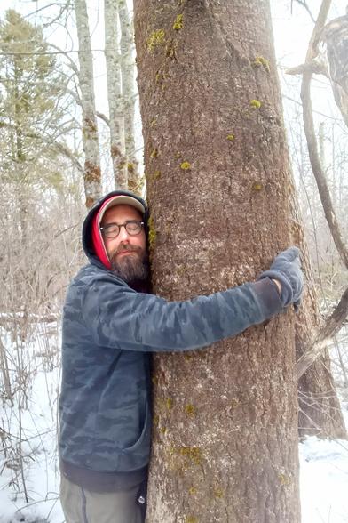 A person hugging a tree