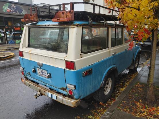 Blue and white Toyota land cruiser from the late 60s-70s
