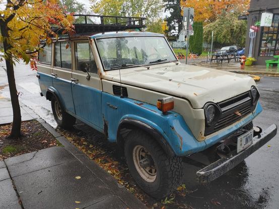 Blue and white Toyota land cruiser from the late 60s-70s