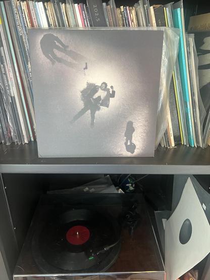 Picture of the band Slint’s 10” record on display on a shelf of vinyl. Hi-fi is also visible and playing said record.