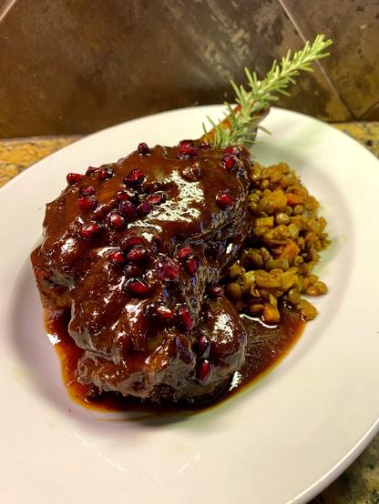 The wine and stock is fully reduced into a sauce, ladled over the lamb, and garnished with pomegranate seeds.

I've come to this lamb year after year, set over the traditional Italian lentils that are typical of New Year's prosperity.   (If not something like cotechino sausage)