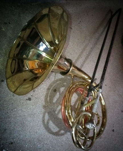 A horn like brass musical instrument made from a combination of recycled brass instruments & a gramophone bell