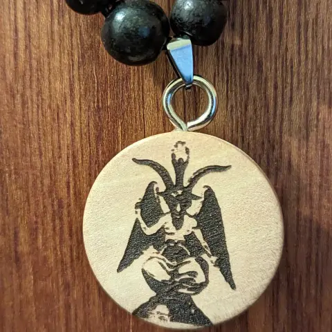 Wooden necklace with Baphomet figure on it.