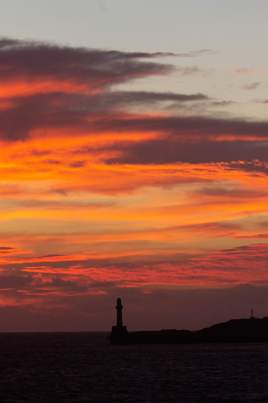 Orange and red sunrise looking towards Aberdeen harbour entrance.
