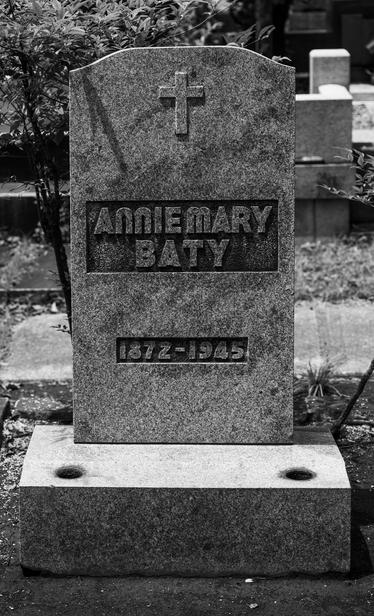 A simple granite tombstone, inscribed as above.
