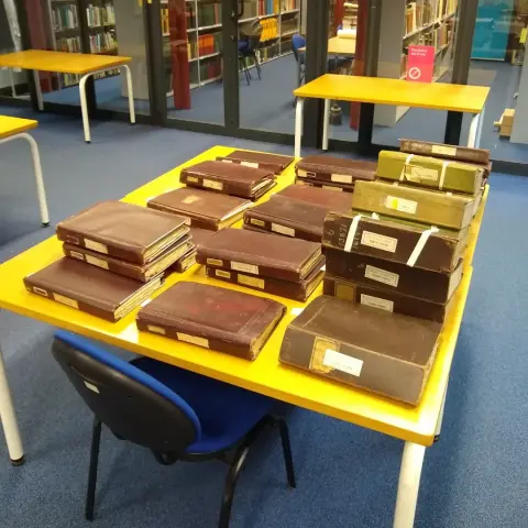 A table full of order books for machine tools manufactured by Craven Brothers Ltd. The volumes are unpackaged.