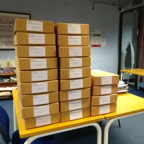 22 archive boxes stacked in three columns on a table. The boxes contain order books for machine tools manufactured by Craven Brothers Ltd.