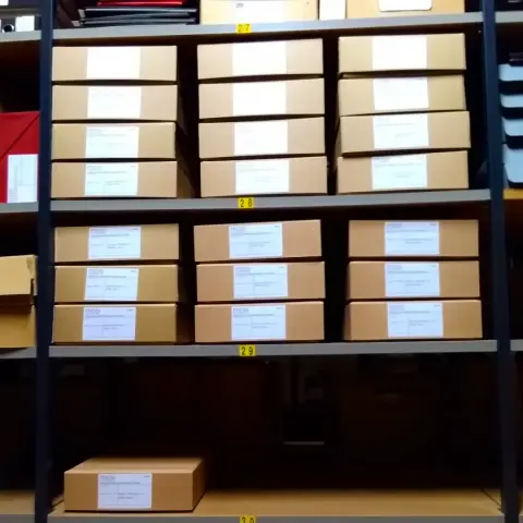 22 archive boxes on shelves in an archive store. The boxes contain order books for machine tools manufactured by Craven Brothers Ltd.