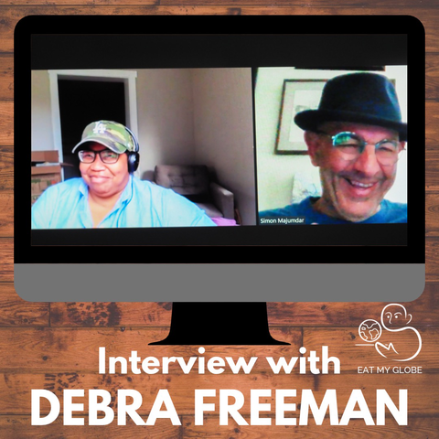 Simon Majumdar and Debra Freeman on a split screen computer graphic. Includes the text, “Interview with Debra Freeman.” Also includes the Eat My Globe logo of Simon Majumdar's likeness using the initials "S" and "M" holding a globe on a platter with the words, "Eat My Globe," underneath.