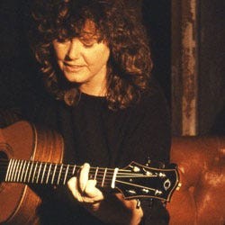 Singer Cheryl Wheeler playing her guitar.