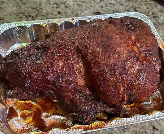 Smoked pork butt in a foil pan