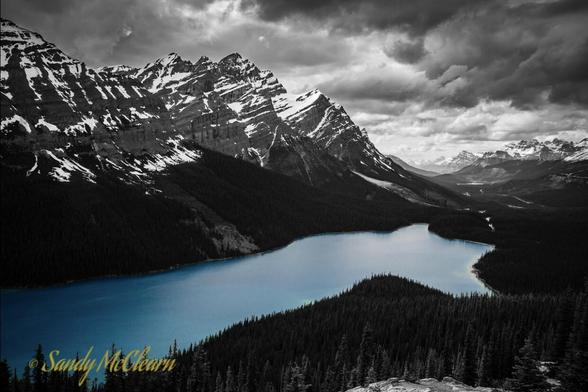 Selective colour landscape photo of Peyto Lake with the lake itself in colour and the rest in black and white.