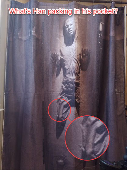 Picture of a Han  Solo shower curtain annotated with a magnification of a long, thick cylindrical object in his right pocket, and the text "What's Han packing in his pocket?"