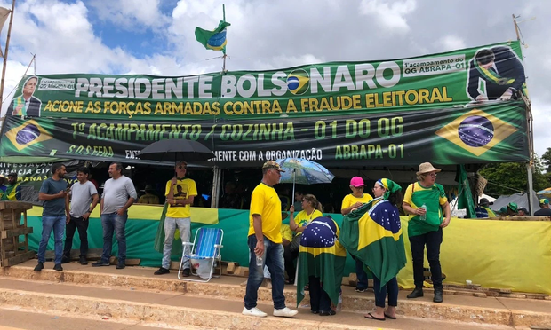 A photograph of a pro-Bolsonaro occupation. The class interests of the participants are clear in the expensive decor, including professionally produced banners, and the visibly wealthy participants.
