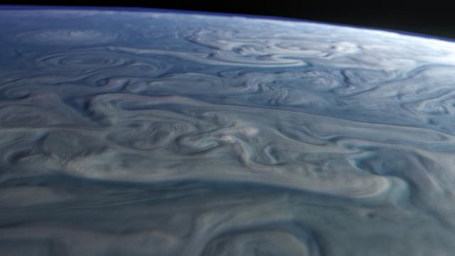 Huge twisted and mangled storms and clouds flows in Jupiter's northern polar latitudes.