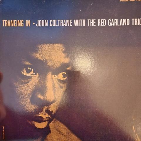 John Coltrane looking off to the right of camera.