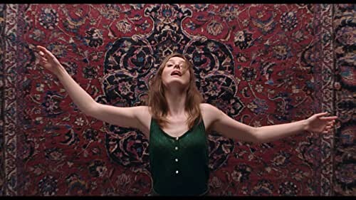 A still from The Worst Person In The World; the main character appears to be falling towards a rug, arms outstretched...