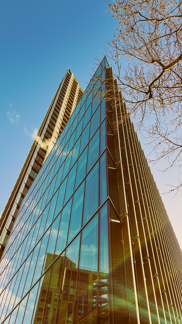 A glass skyscraper reflecting the sky