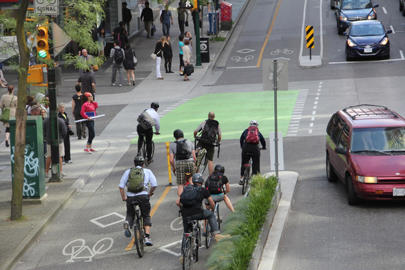 People on bikes in protected bike-lane in Vancouver