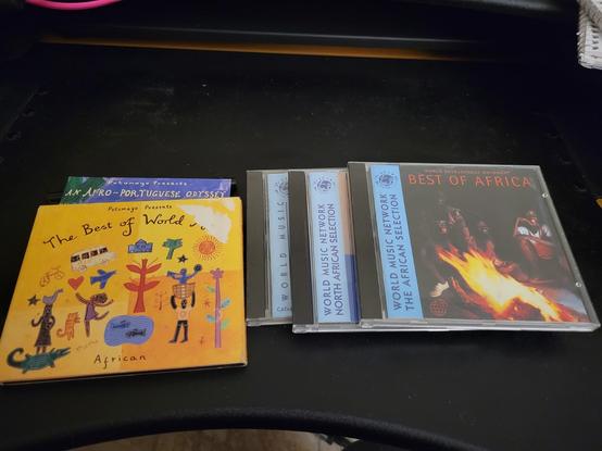 Small stack of Putomayo and Rough Guide CDs