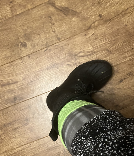 Winter boot, neon green sock, grey tartan tights.
