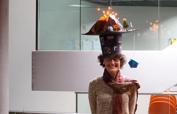 Photo of Clarissa Kroll wearing her hand-made doctoral hat after the defense. It is a tradition that fellow PhD candidates make it for the graduating colleague. It showcases what the respective person has been working on during their PhD and what the person is interested in.