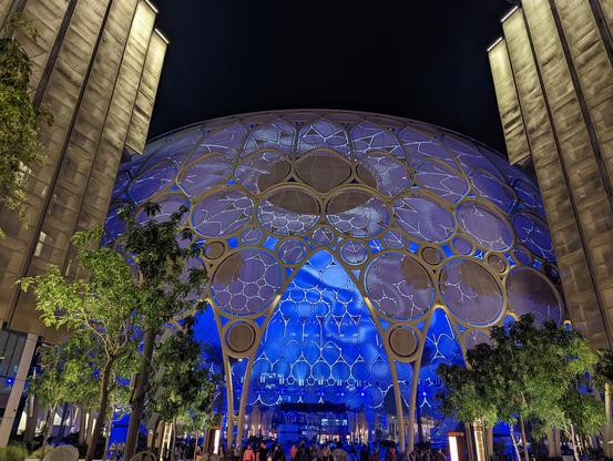 The Al Wasl Dome at night, lit up from the inside by projections.