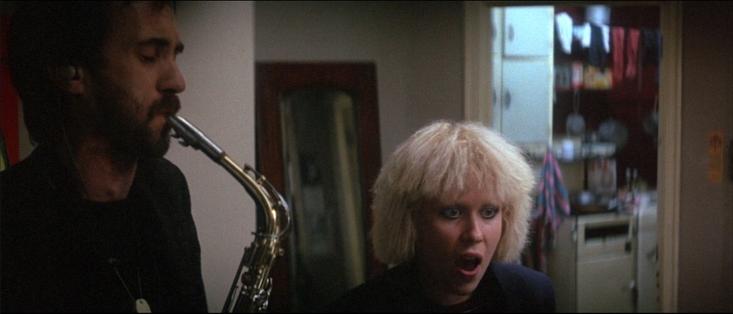 Saxophonist and singer rehearsing.
