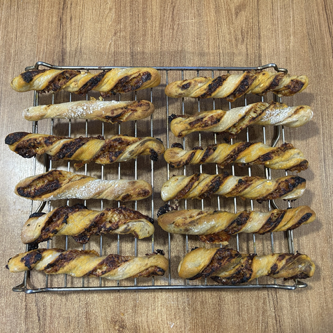 The sticks freshly out of the oven. What was white os now golden, with still flecks of white from the flour I sprinkled over them; the red wounds have opened and are dark bronze. They look rather wonderful and smell even better.