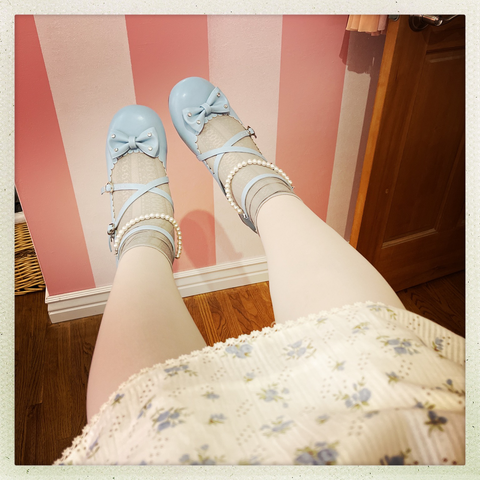 A detail of the hemline and shoes