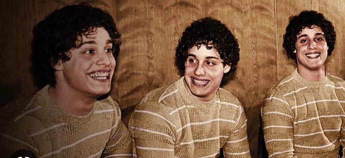 The triplets at the age of 19 wearing the same brown white striped sweater.