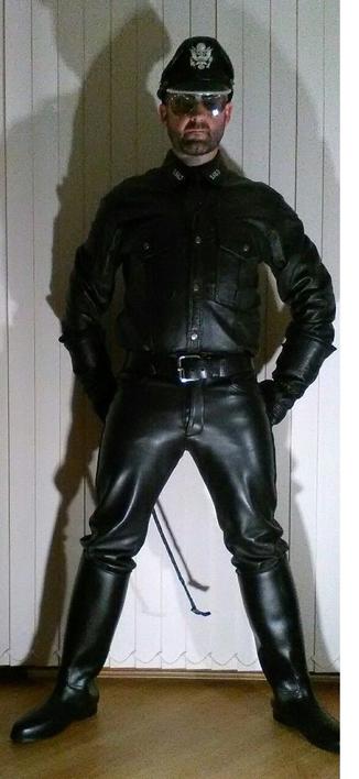 Photo of me in my full black BLUF leathers with a dominant stance and of course my riding crop to punish any bold disobedient submissives.