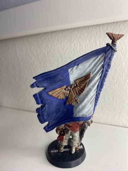 Back of an imperial standard painted blue and white, with the golden Aquila.