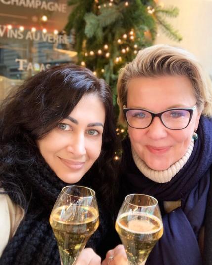 Sabrina Rani Furminger and Amanda Tapping clink champagne glasses in Paris.