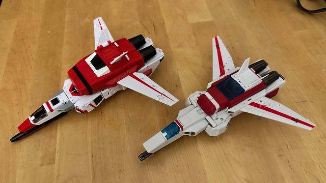Two jet transformers next to each other for comparison, both different takes on Jetfire:

NewAge Firebird, decorated in red and black to match the original toy despite the design sewing close to the cartoon design.

Magic Square Meteor, in a colour scheme far closer to the cartoon design.