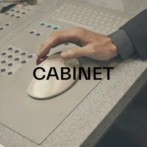 Promotional graphic for fashion brand Cabinet. Photo of a hand touching the ball of a Logitech Trackman mouse (with the branding removed) from the wrong angle.