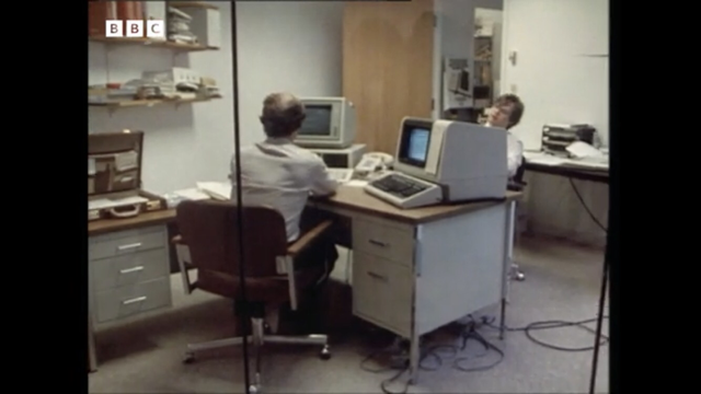 Infocom offices with DEC-VT100 terminals and IBM 5540 porting a program.