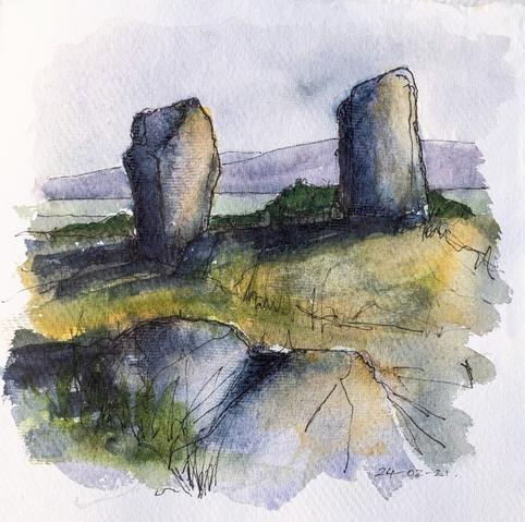 A pair of large stones, casting long shadows, stand on the near horizon with sea and hills in the distance. A fallen stone lies in the foreground. Loose pen an watercolour in muted greens, blues and purples.