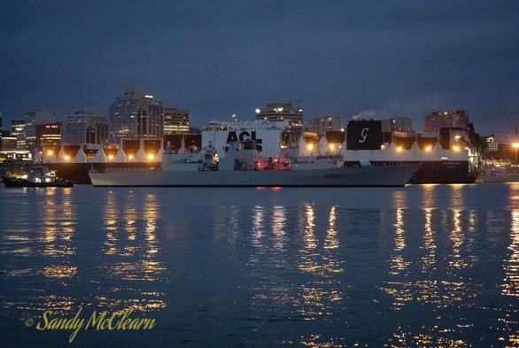 Warship passing container ship.