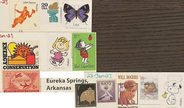 A variety of modern & classic stamps. A $.13 USA dance theater Square $.29 torch purple dogface butterfly stamp Tiffany lamp one cent stamp NATO three cent stamp will Rogers performing arts $.15 stamp an otter in some water. A snoopy stamp $.13 energy conservation stamp six 50th anniversary of powered flight stamp another snoopy stamp. It’s the blonde who has a pink dress. Also a forever stamp Shel Silverstein the giving tree.