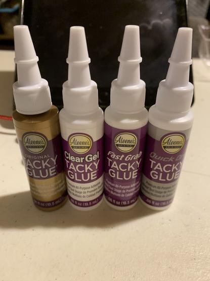 4 tiny trial sized bottles of Aleene’s glue from left to right: 1. Original 2. Clear tacky 3. Fast grab tacky 4. Quick dry tacky