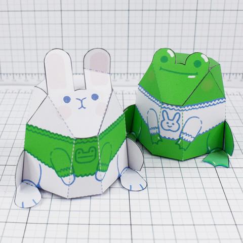 A photo of a frog and a rabbit wearing jumpers of a frog and a rabbit