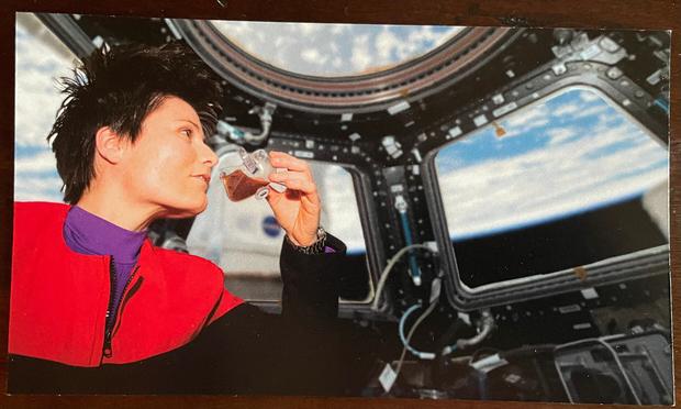 Astonaut Samantha Cristoforetti drinking from the space cup in the International Space Station