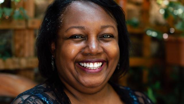 Malorie Blackman smiling at the camera. Photo credit: Paul Akinrinlola