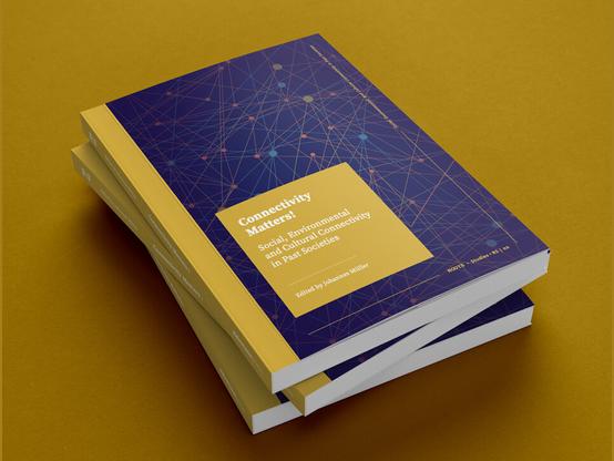 The photo shows three copies of the book Connectivity Matters stacked on top of each other on a yellow background.
