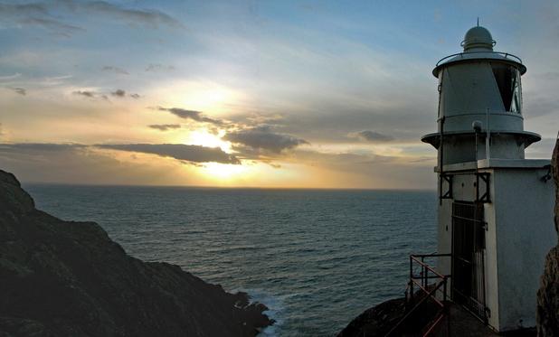 Winter sunset over the sea with lighthouse
