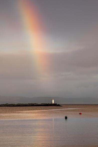 #Photograph of a #Rainbow hitting the #Lighthouse on one of the islands in the bay. Overcast sky, fairly calm sea so got a bit of a reflection.