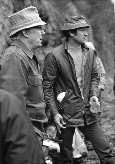 Dr. Marvin Beeson (right) and Dr. Jonathan Elliott Allen of Portland State University gaze to the right of the frame while conducting a lecture in the field on the Columbia River Basalt.

Black and white photo shows the two geologists in front of a blurred outcrop, with Dr. Beeson holding a rock hammer in right hand and a rock hand specimen in left.

Picture circa early 1970s.